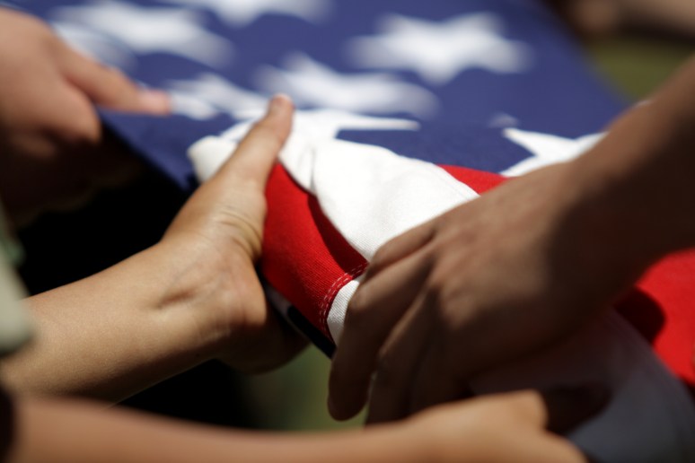 Young Marines fold a flag for Memorial Day.