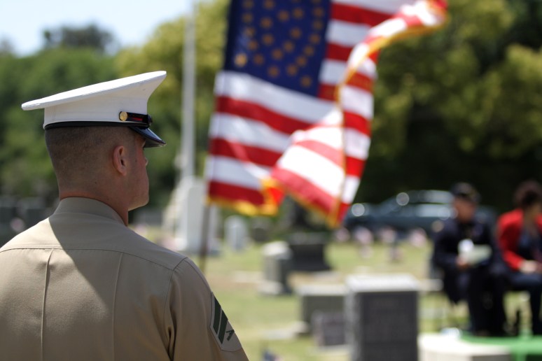 Cpl. Adams supervises as members of the MCAS Miramar Young Marines conduct a flag folding ceremony.