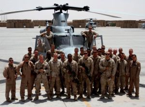 Cpl. Brandon Moore, an infantryman with 1st Battalion, 8th Marines, (back row right, in front of helicopter door) poses with his squad and the Marine Light Attack Helicopter Squadron 469 "Vengeance" aircrew who provided vital close air support during the ill-fated June 22, 2012, Operation Jaws, on the Camp Bastion, Afghanistan, flightline in July 2012.